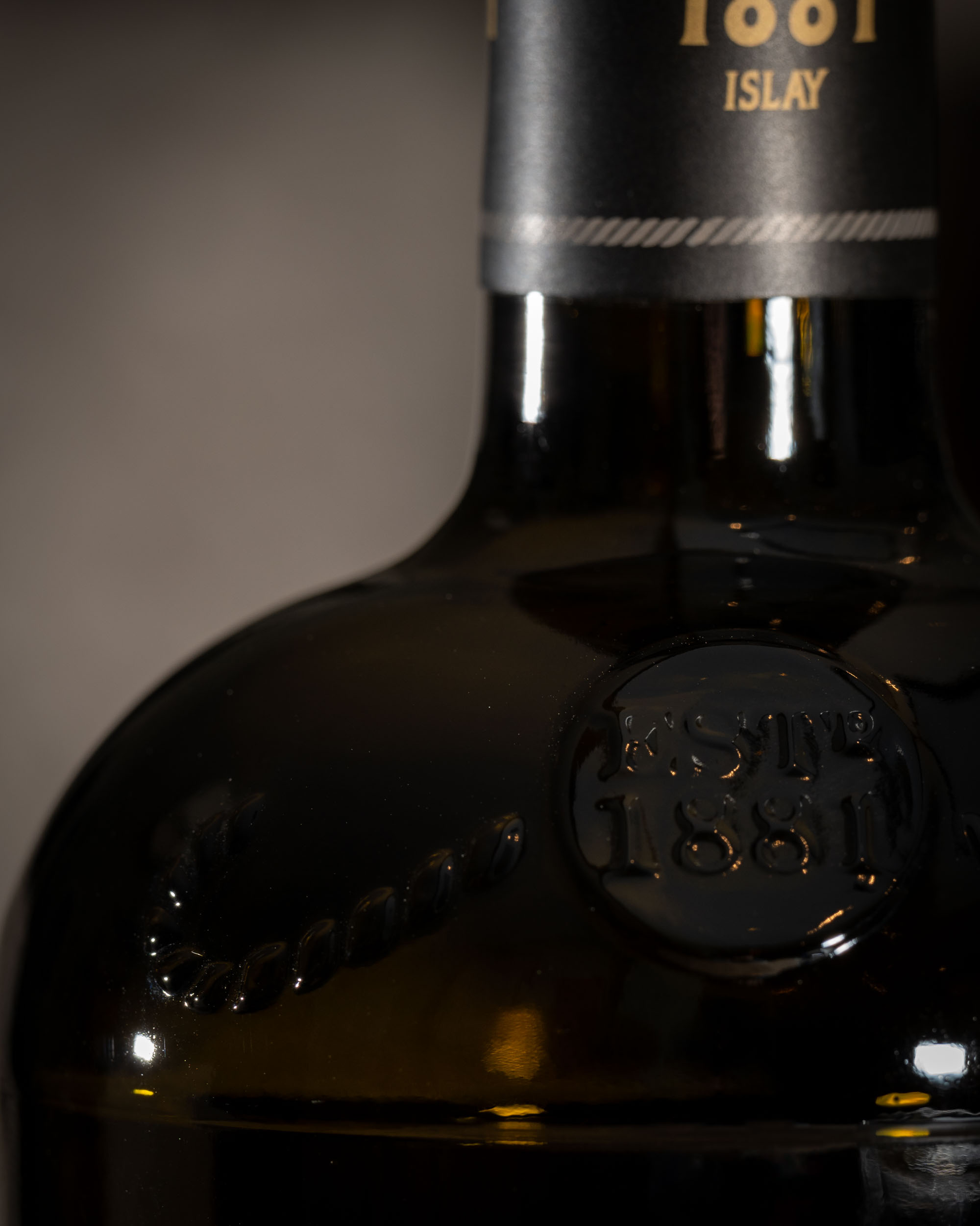 Close-up of the embossed ESTD 1881 detail on the Bunnahabhain Stiùireadair bottle
