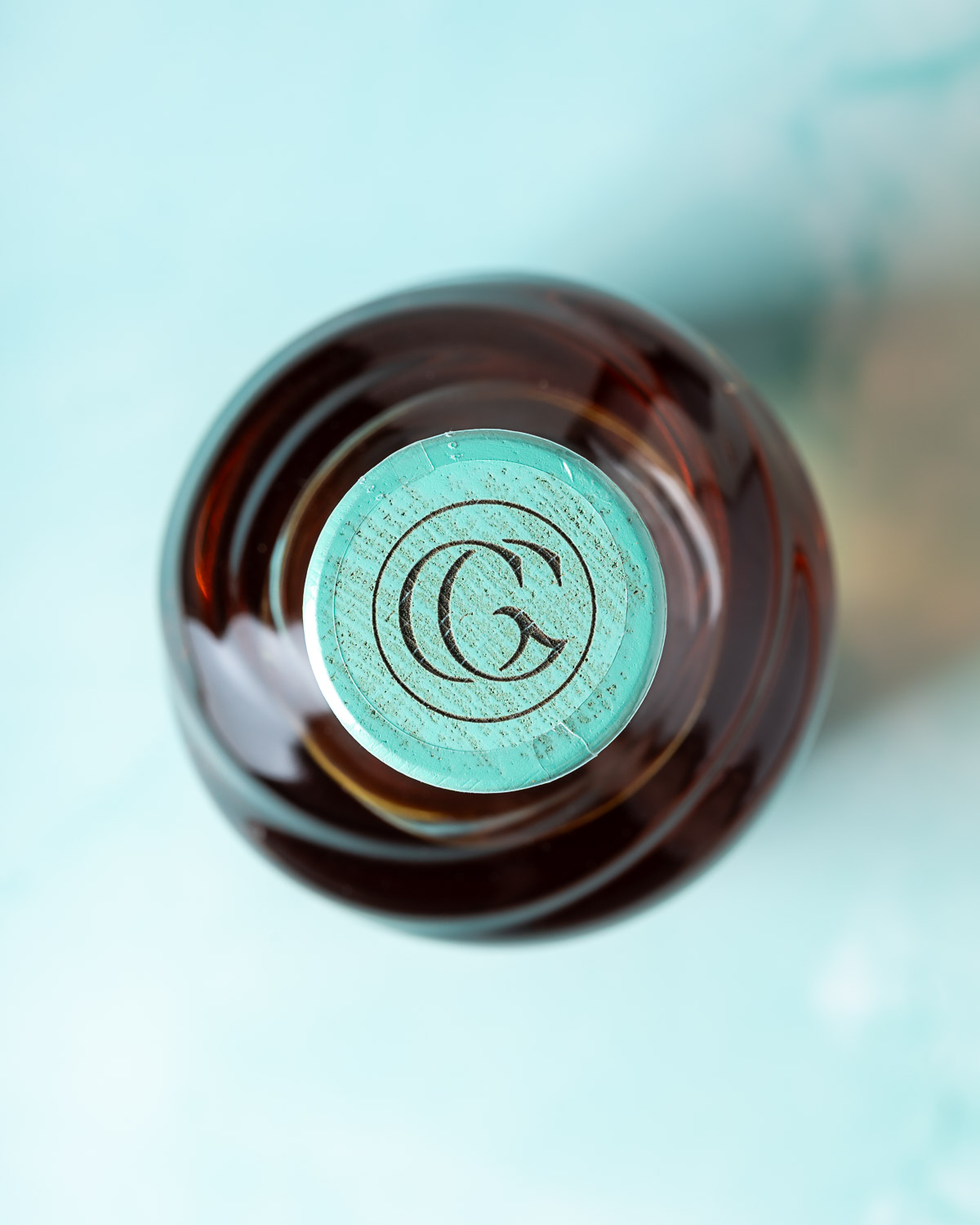 Overhead view of the mint-green stopper embossed with the Glenglassaugh monogram