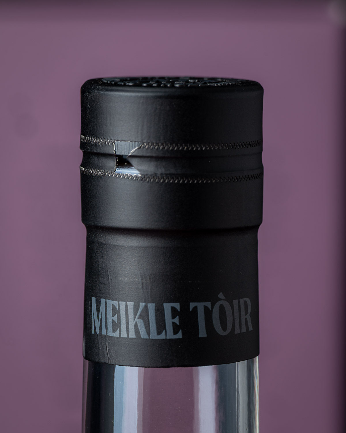 Close-up of the bottle neck and capsule embossed with the Meikle Tòir name
