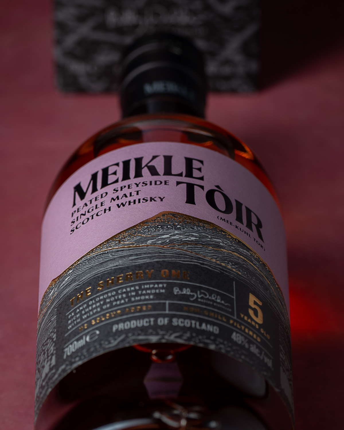 Angled view of the mauve label showing the Meikle Tòir and The Sherry One branding